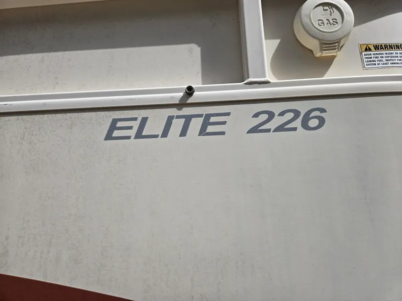 Slide: The Image of 2008 Starcraft Elite 226 RE CR boat exterior with gas cap and warning label. - 11