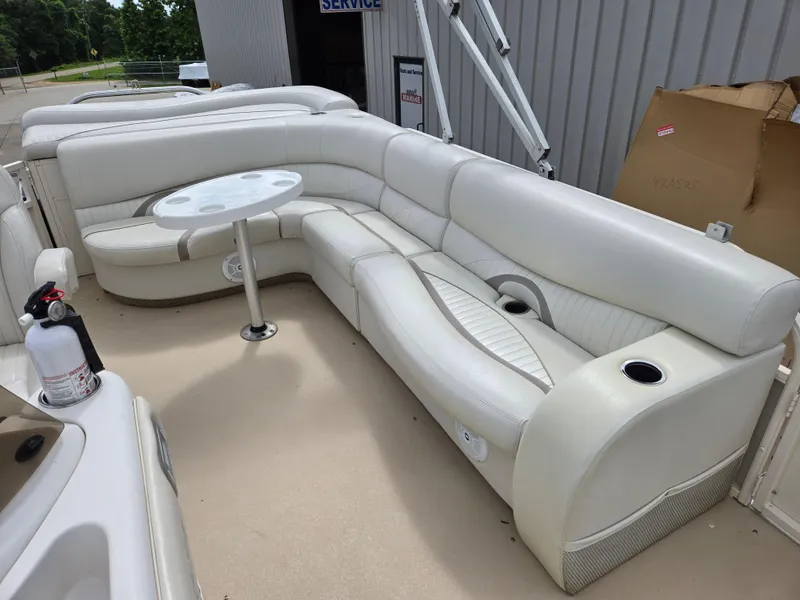 Slide: The Image of 2008 Starcraft Elite 226 RE CR boat interior with white seating and table. - 14