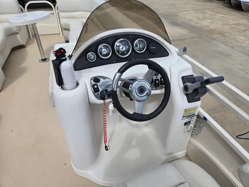 Slide: The Image of Steering console of a 2008 Starcraft Elite 226 RE CR boat with gauges and controls. - 15