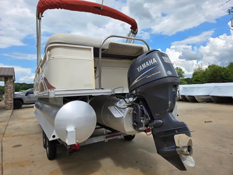 Slide: The Image of 2008 Starcraft Elite 226 RE CR pontoon boat with Yamaha outboard motor, parked outdoors. - 18