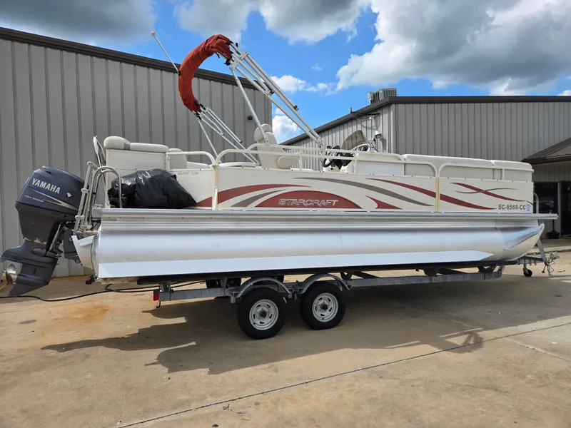 Slide: The Image of 2008 Starcraft Elite 226 RE CR pontoon boat on trailer, with Yamaha outboard motor. - 2