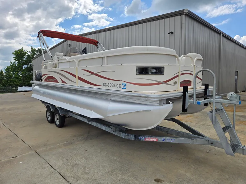 Slide: The Image of 2008 Starcraft Elite 226 RE CR pontoon boat on trailer, parked outside a warehouse. - 3