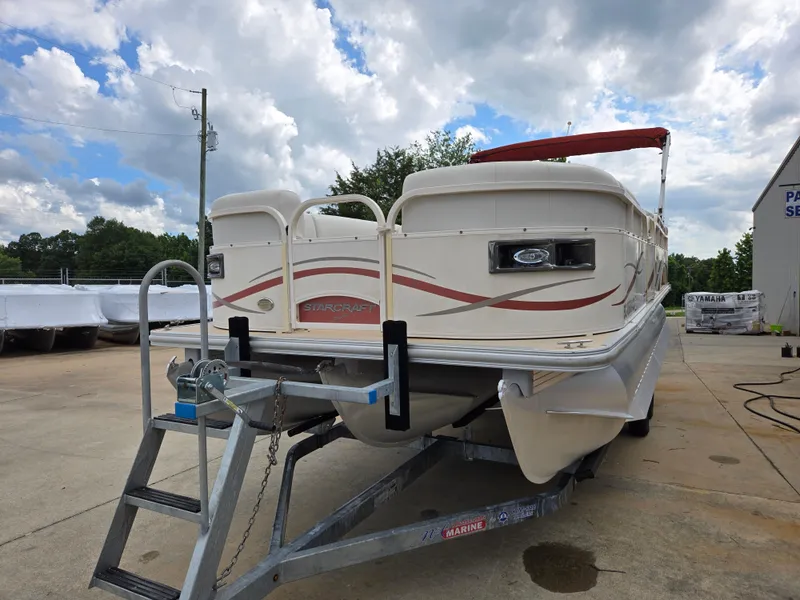 Slide: The Image of 2008 Starcraft Elite 226 RE CR pontoon boat on trailer, parked outdoors under cloudy sky. - 4