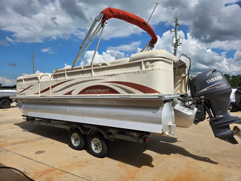 Slide: The Image of 2008 Starcraft Elite 226 RE CR pontoon boat with Yamaha engine on trailer. - 5