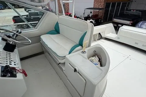 Slide: The Image of 1997 Stamas 310 Express boat interior with white seating and helm station. - 10