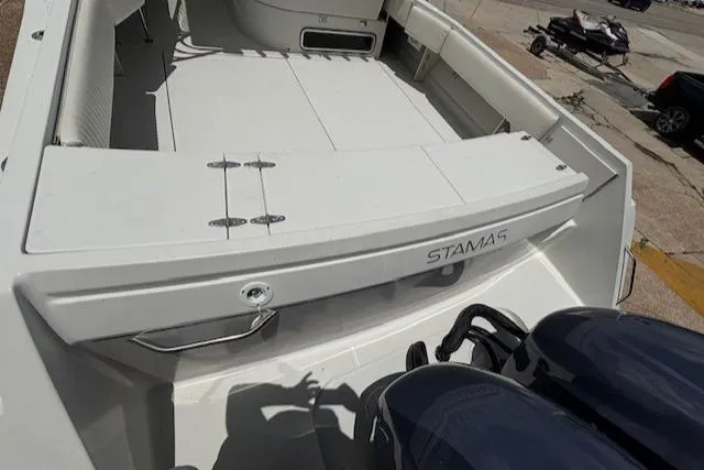 Slide: The Image of 1997 Stamas 310 Express boat deck with dual engines, viewed from above. - 14