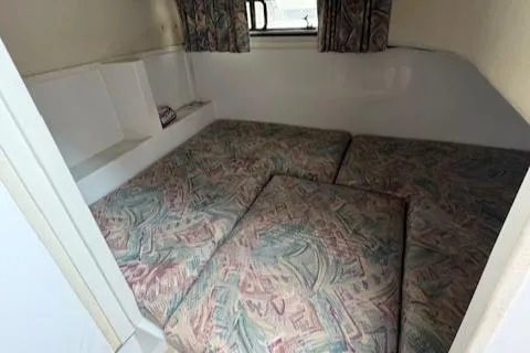 Slide: The Image of Interior cabin of 1997 Stamas 310 Express with patterned cushions and window. - 7