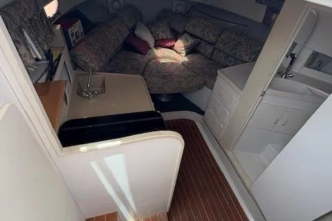 Slide: The Image of 1997 Stamas 310 Express cabin interior with seating, sink, and wood flooring. - 9
