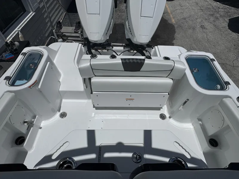 Slide: The Image of 2025 Wellcraft 242 Fisherman boat interior with dual engines and seating area. - 10
