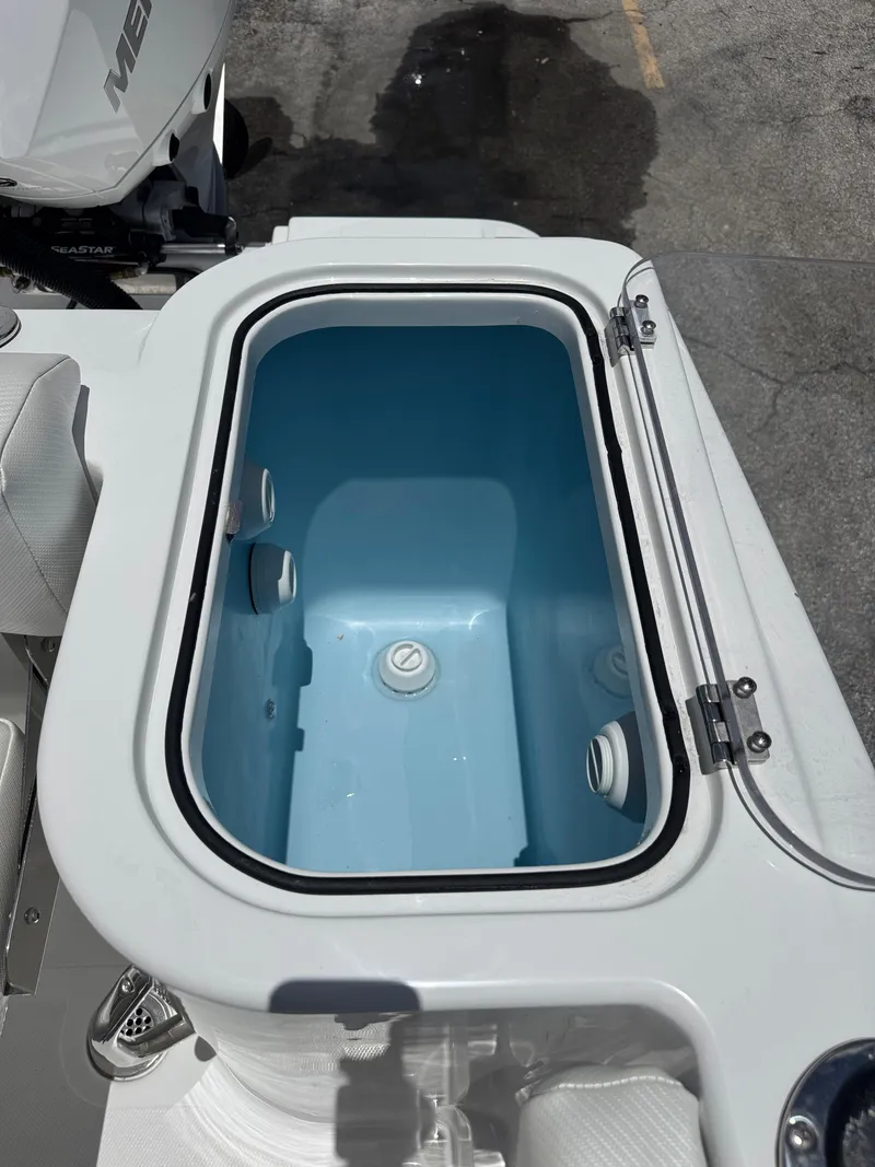 Slide: The Image of 2025 Wellcraft 242 Fisherman livewell with open lid, showcasing interior design. - 12