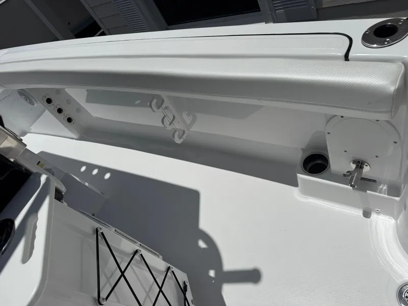 Slide: The Image of 2025 Wellcraft 242 Fisherman boat interior, featuring sleek white seating and fishing rod holders. - 15