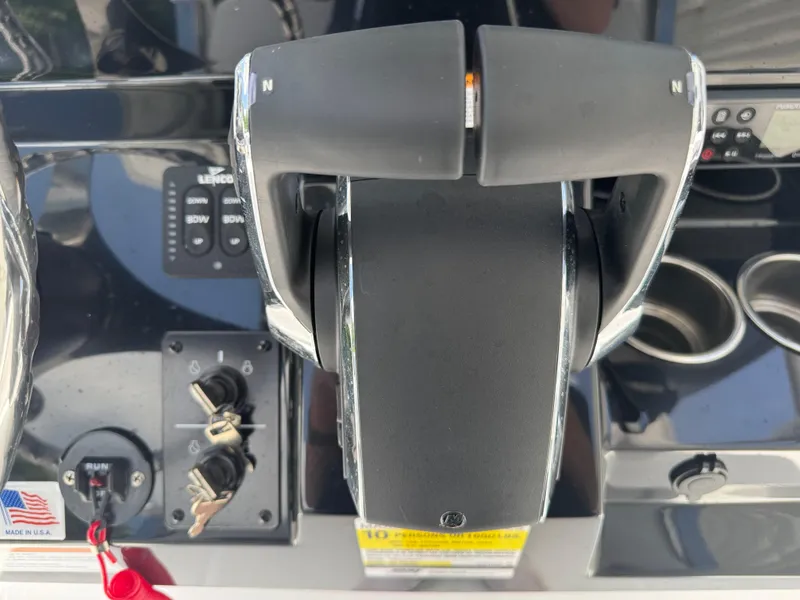 Slide: The Image of Control panel of 2025 Wellcraft 242 Fisherman boat with throttle and ignition keys. - 17