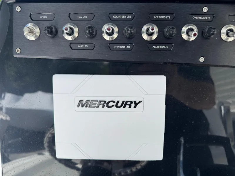 Slide: The Image of Control panel of 2025 Wellcraft 242 Fisherman boat with Mercury branding. - 18