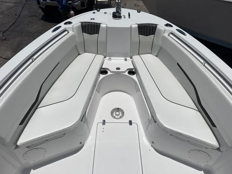 Slide: The Image of 2025 Wellcraft 242 Fisherman boat interior with white cushioned seating and sleek design. - 21