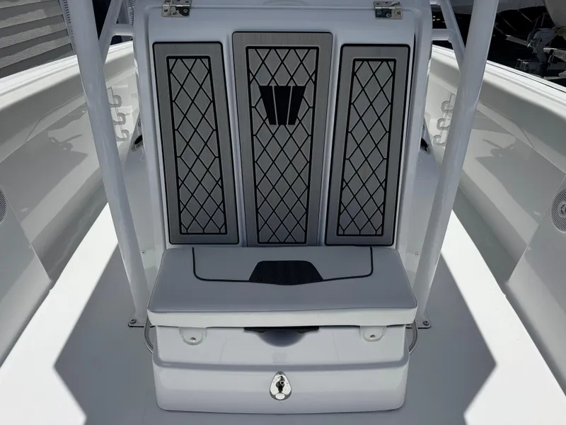 Slide: The Image of 2025 Wellcraft 242 Fisherman boat interior with cushioned seating and storage compartment. - 26