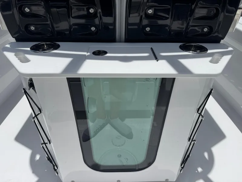 Slide: The Image of 2025 Wellcraft 242 Fisherman boat console with storage and cup holders. - 6