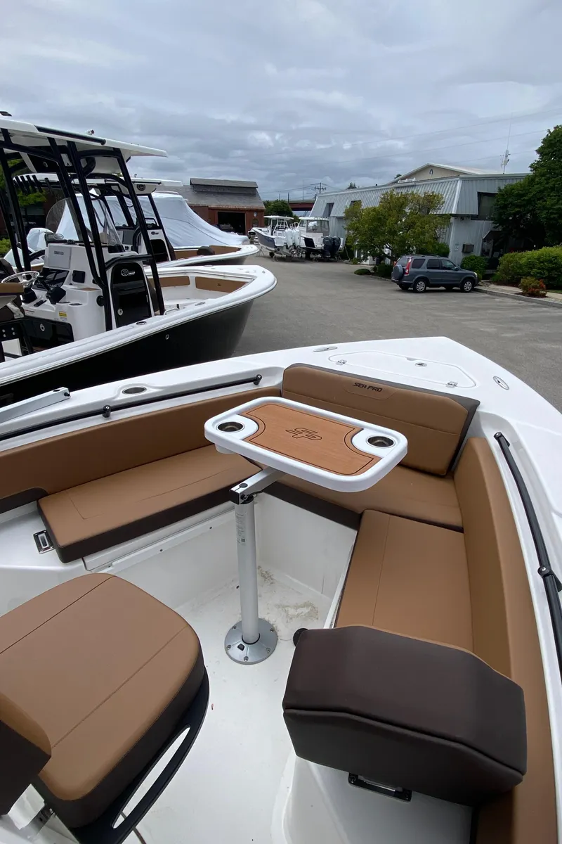 Slide: The Image of 2025 Sea Pro 225 Sandbar boat with brown seating and a central table. - 10