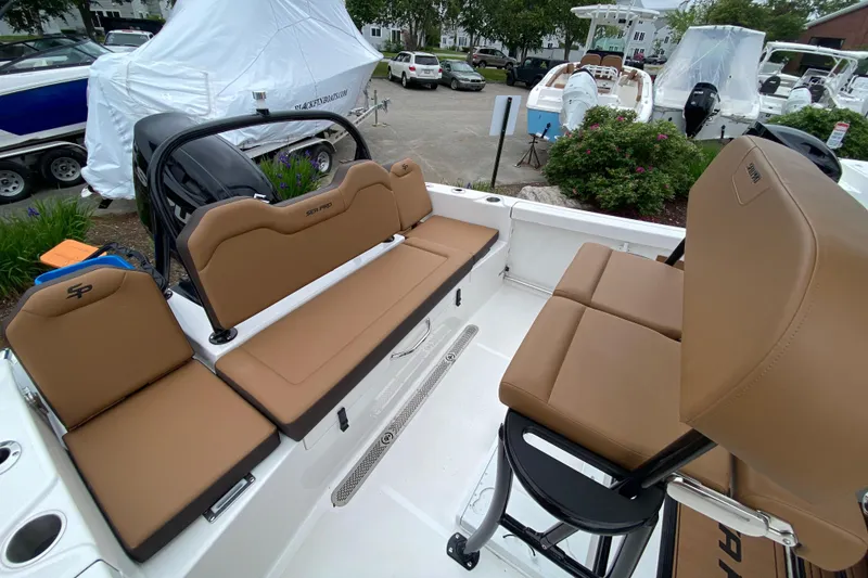 Slide: The Image of 2025 Sea Pro 225 Sandbar boat interior with tan seating and sleek design. - 4