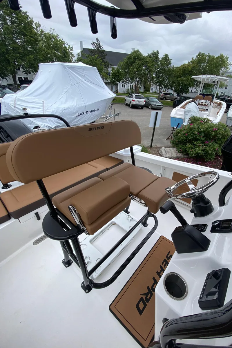 Slide: The Image of 2025 Sea Pro 225 Sandbar boat interior with tan seating and steering wheel. - 6