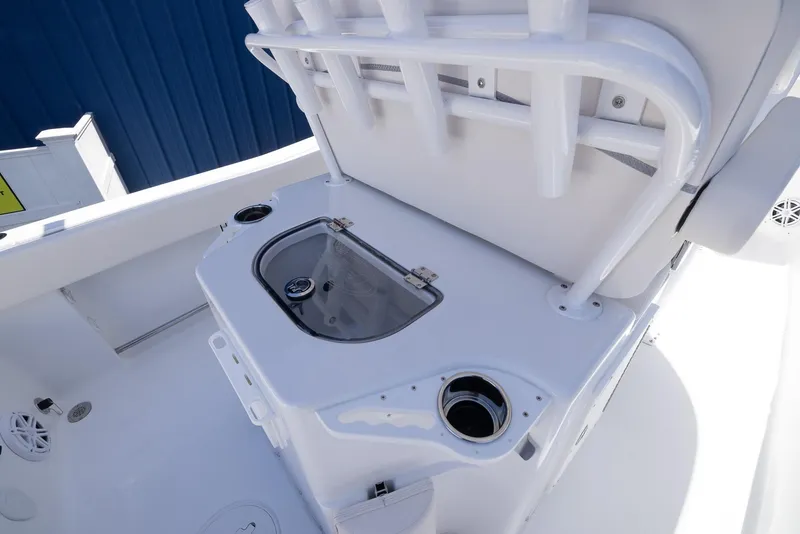 Slide: The Image of 2026 Sea Hunt Ultra 235 SE boat interior with livewell and rod holders. - 13