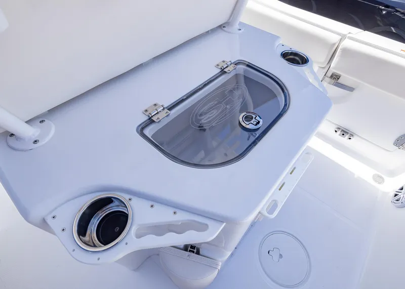Slide: The Image of 2026 Sea Hunt Ultra 235 SE boat interior with storage compartment and cup holders. - 14