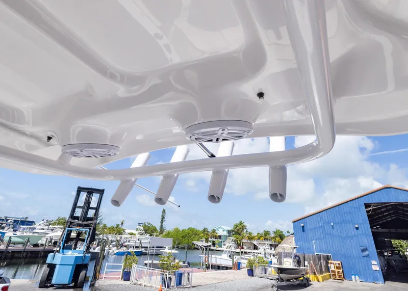 Slide: The Image of 2026 Sea Hunt Ultra 235 SE boat with rod holders and speakers, dockside view. - 16