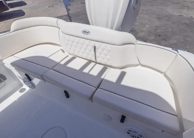 Slide: The Image of 2026 Sea Hunt Ultra 235 SE boat seating with white cushioned upholstery. - 17