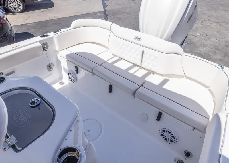 Slide: The Image of 2026 Sea Hunt Ultra 235 SE boat interior with white seating and storage compartments. - 18