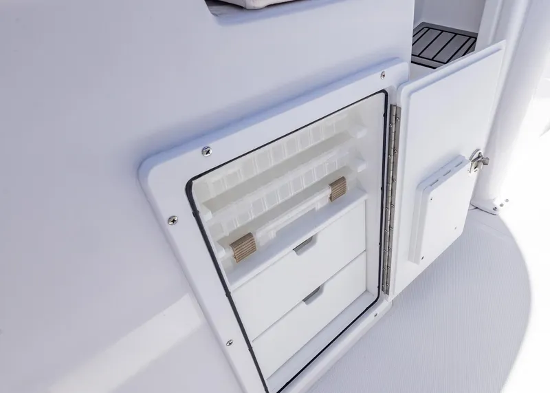 Slide: The Image of Open storage compartment on 2026 Sea Hunt Ultra 235 SE boat. - 20