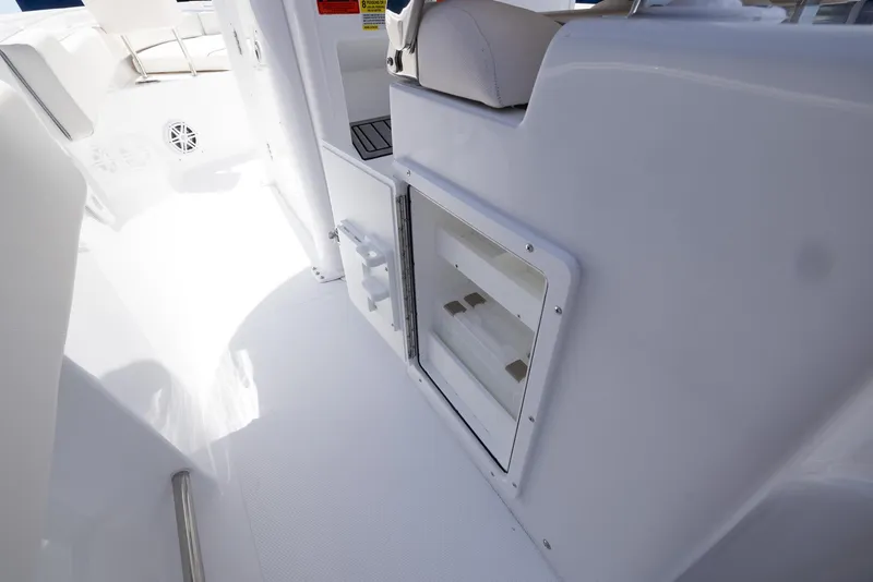 Slide: The Image of Interior view of 2026 Sea Hunt Ultra 235 SE boat, featuring sleek white design. - 21