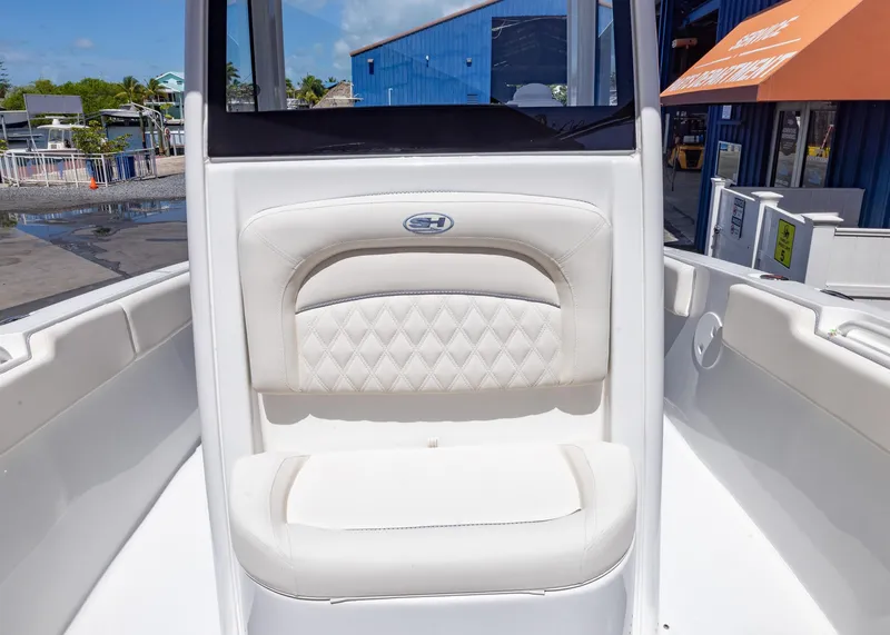 Slide: The Image of 2026 Sea Hunt Ultra 235 SE boat interior with white cushioned seating. - 4