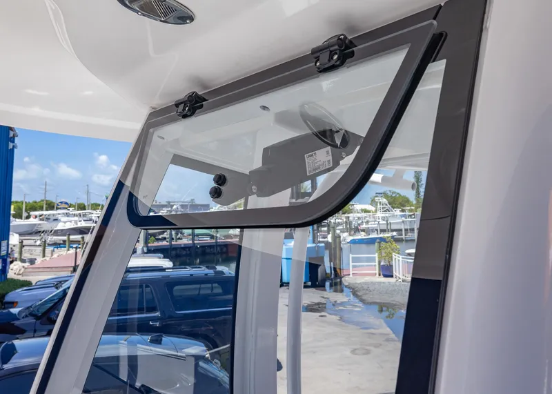 Slide: The Image of 2026 Sea Hunt Ultra 235 SE boat windshield detail at marina. - 5