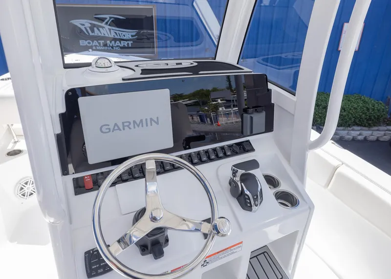 Slide: The Image of 2026 Sea Hunt Ultra 235 SE boat dashboard with Garmin navigation system. - 6