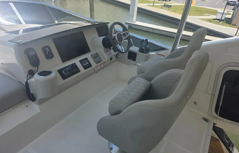 Slide: The Image of Cockpit of 2021 Absolute 47 Fly yacht with modern controls and plush seating. - 10