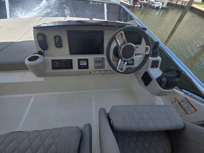 Slide: The Image of Cockpit of 2021 Absolute 47 Fly yacht with modern steering and controls. - 11