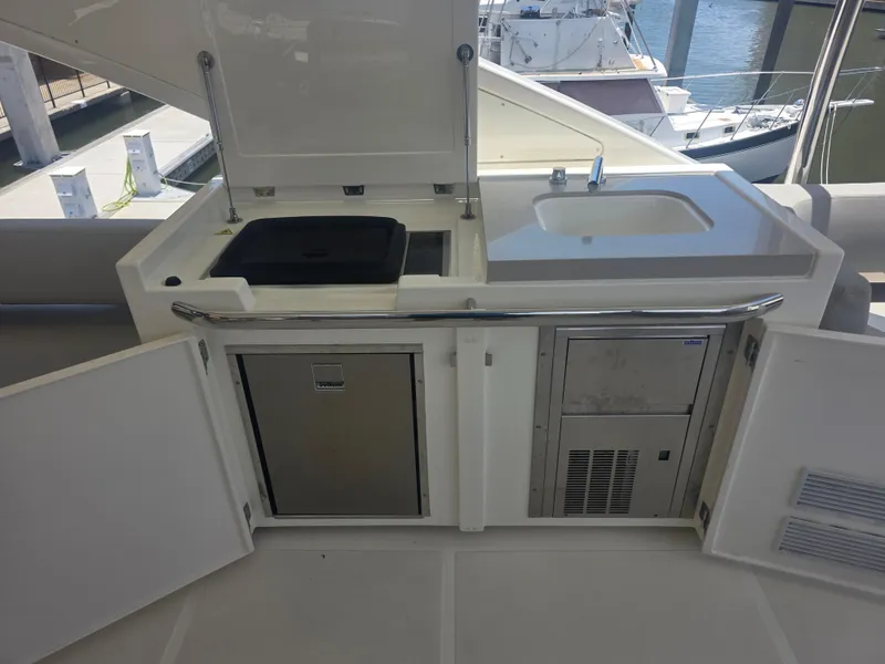 Slide: The Image of Outdoor kitchenette on 2021 Absolute 47 Fly yacht with sink and storage. - 13