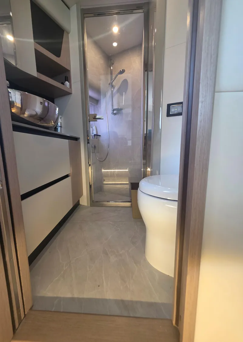 Slide: The Image of Modern bathroom interior on 2021 Absolute 47 Fly yacht, featuring shower and toilet. - 21