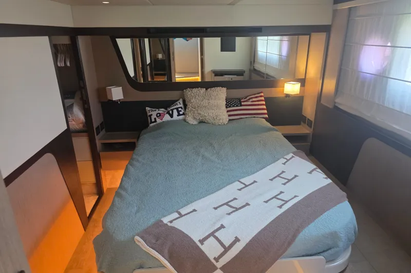 Slide: The Image of Luxurious bedroom interior of 2021 Absolute 47 Fly yacht with cozy bedding and stylish decor. - 28