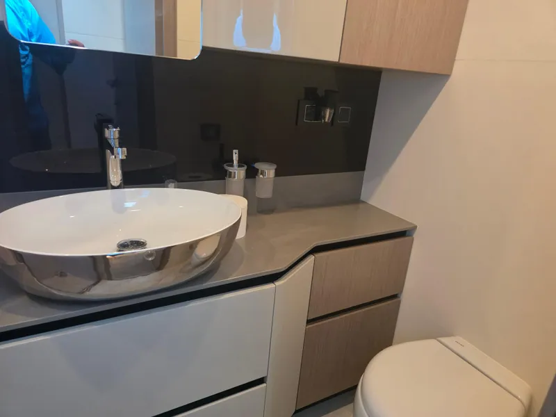 Slide: The Image of Modern bathroom in 2021 Absolute 47 Fly yacht with sleek sink and cabinetry. - 31