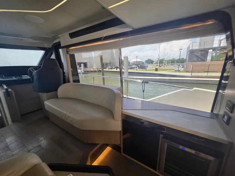 Slide: The Image of Interior of 2021 Absolute 47 Fly yacht with modern seating and large window view. - 37