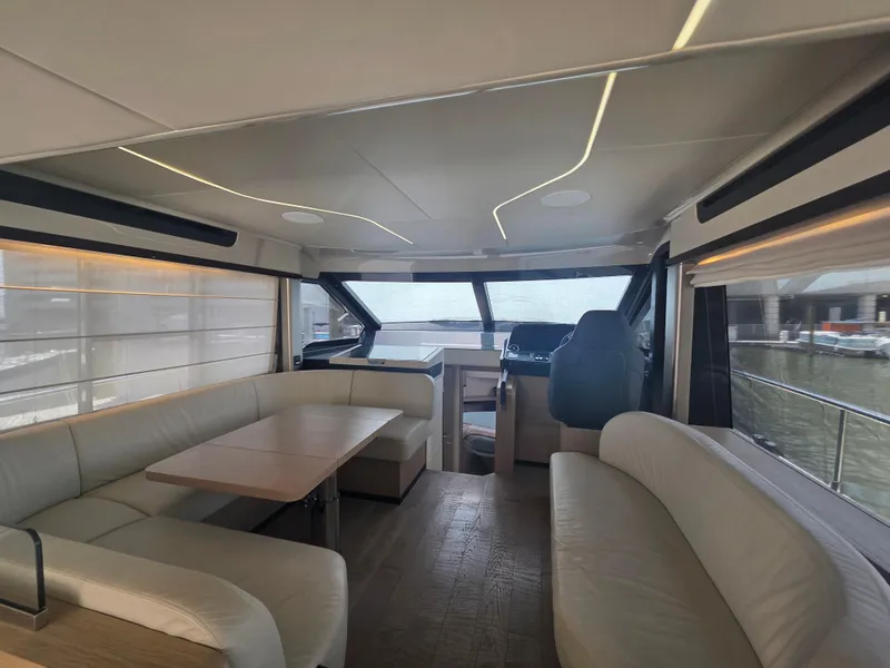 Slide: The Image of Luxurious interior of 2021 Absolute 47 Fly yacht with modern seating and panoramic windows. - 38