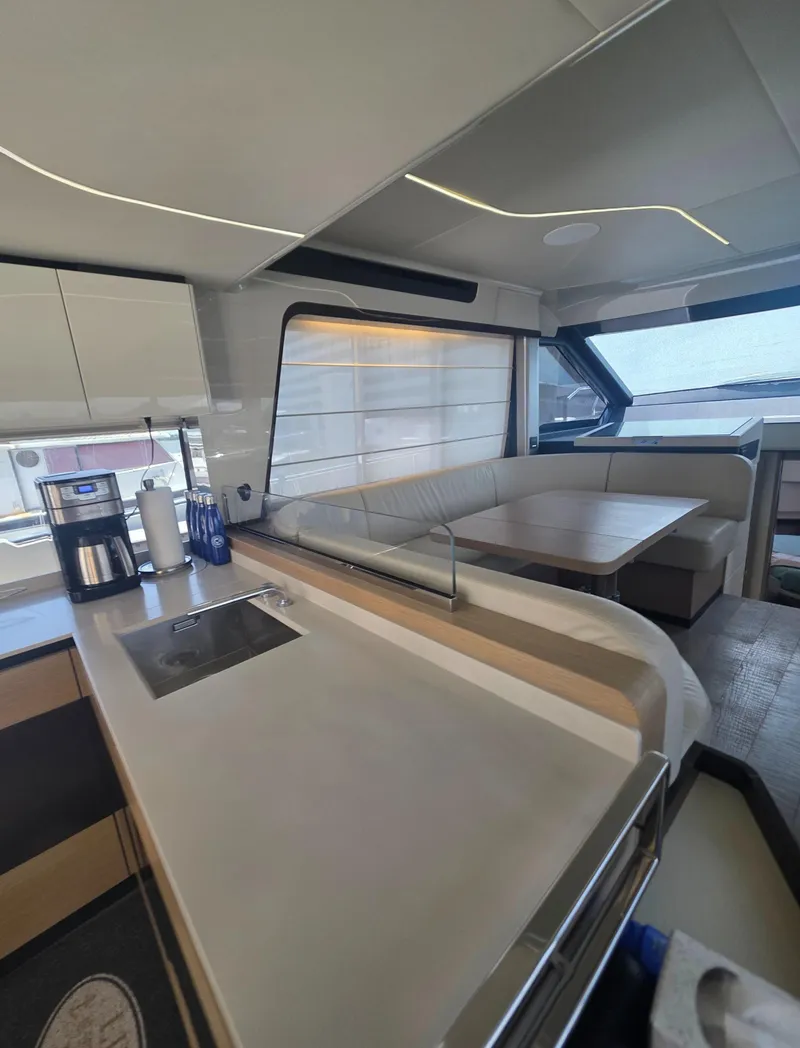 Slide: The Image of Luxurious interior of 2021 Absolute 47 Fly yacht with modern kitchen and seating area. - 47