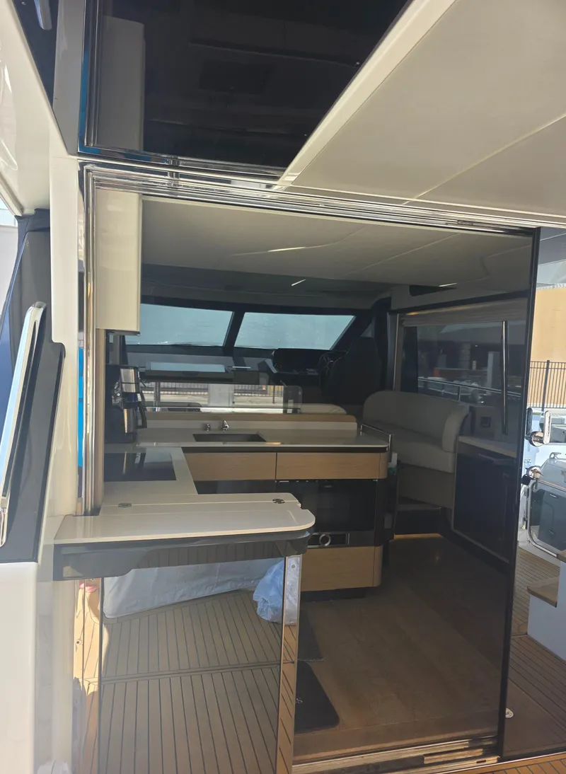 Slide: The Image of Interior view of 2021 Absolute 47 Fly yacht, featuring modern kitchen and seating area. - 49