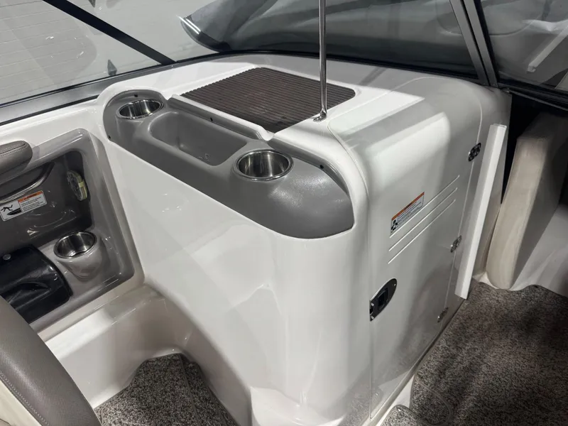 Slide: The Image of Interior of 2011 Yamaha Boats 242 Limited, featuring cup holders and storage compartments. - 12