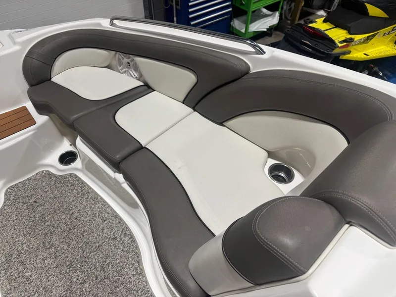 Slide: The Image of 2011 Yamaha Boats 242 Limited interior seating with gray and white upholstery. - 15