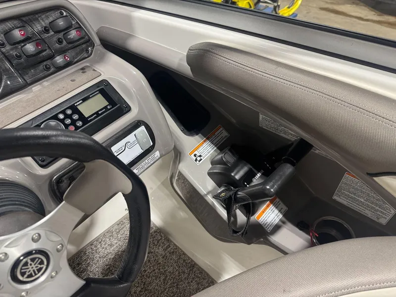 Slide: The Image of 2011 Yamaha Boats 242 Limited dashboard with steering wheel and control panel. - 9