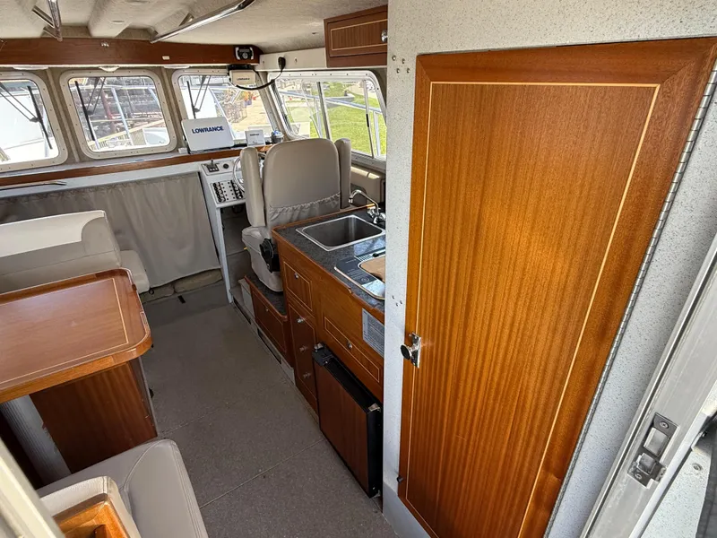 Slide: The Image of Interior of a 2016 KingFisher 3025 Destination boat with wood finishes and navigation equipment. - 10