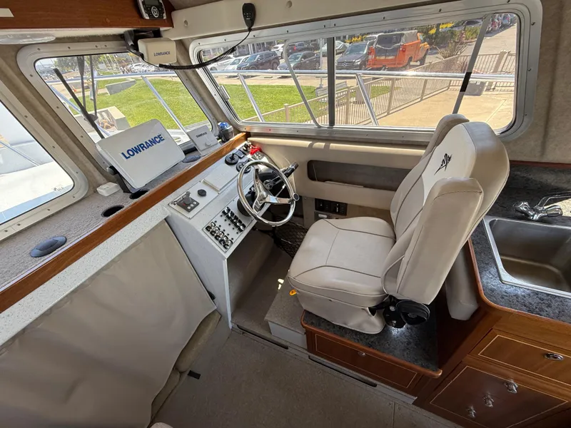Slide: The Image of Interior of 2016 KingFisher 3025 Destination boat with steering wheel and navigation equipment. - 13