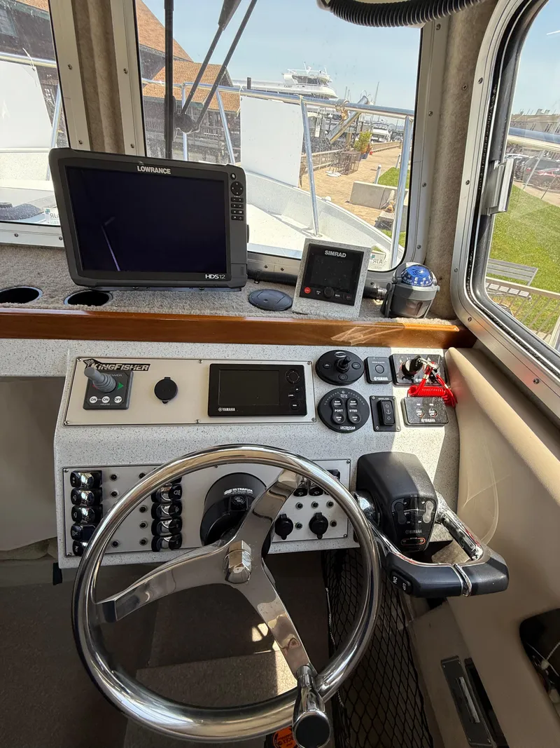 Slide: The Image of Interior view of 2016 KingFisher 3025 Destination boat cockpit with navigation equipment. - 14