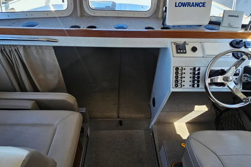 Slide: The Image of Interior of 2016 KingFisher 3025 Destination boat with steering wheel and control panel. - 15